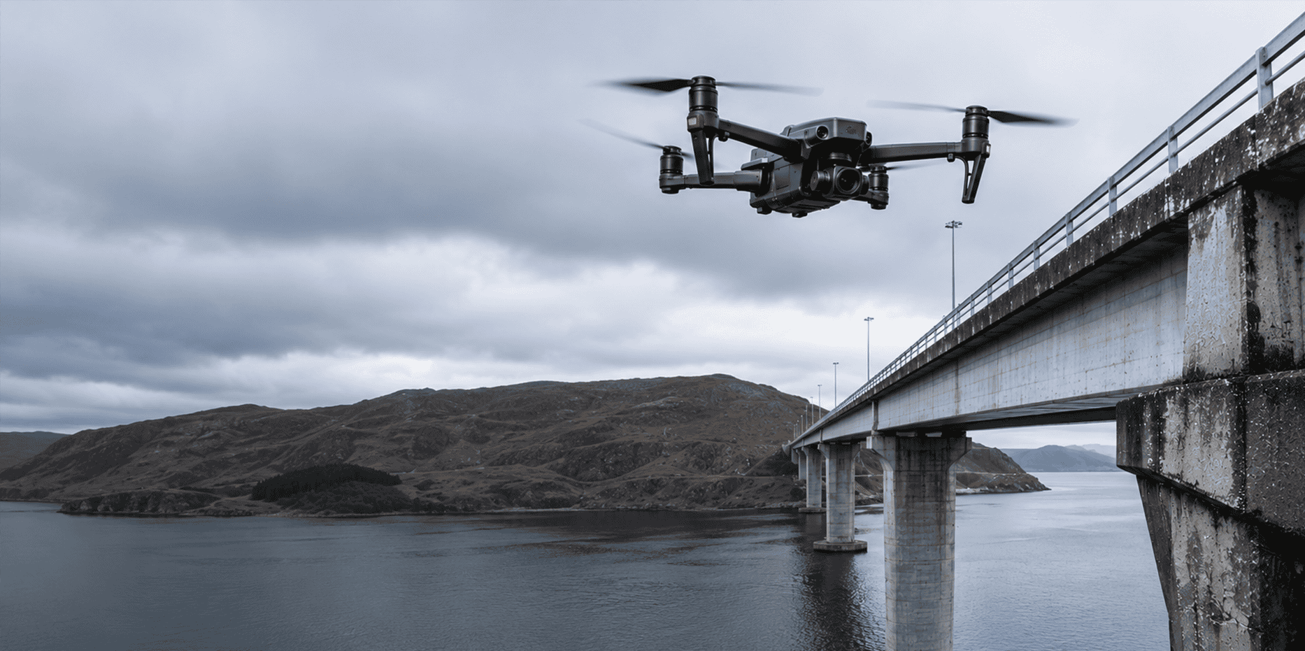 Infrastructure Inspections — drone hovering near a bridge structure